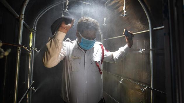 A police personnel walks through a disinfection tunnel in Parliament Street Police station, New Delhi on Friday.(Sanchit Khanna/HT PHOTO) A police personnel walks through a disinfection tunnel in Parliament Street Police station, New Delhi on Friday.(Sanchit Khanna/HT PHOTO)