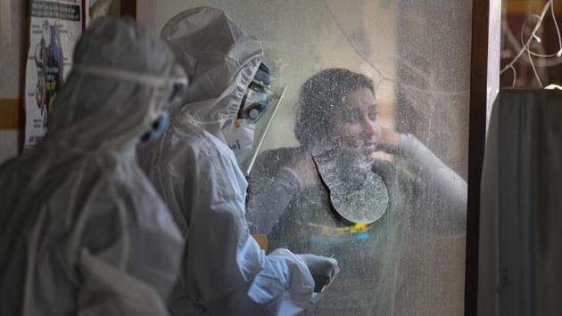 Health workers wearing Personal Protective Equipment (PPE) bodysuits handle a sample at a swab collection booth for COVID-19 testing at a centre in Patel Nagar, New Delhi on June 11. Only the US, Brazil and Russia have more number of Covid-19 cases than India now. (Sanchit Khanna / HT Photo) Health workers wearing Personal Protective Equipment (PPE) bodysuits handle a sample at a swab collection booth for COVID-19 testing at a centre in Patel Nagar, New Delhi on June 11. Only the US, Brazil and Russia have more number of Covid-19 cases than India now. (Sanchit Khanna / HT Photo)