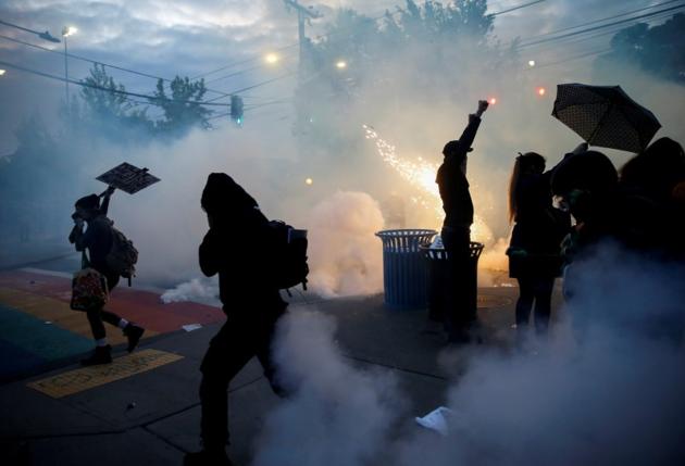 Protesters disperse as tear gas, pepper spray and flash-bang devices are deployed by Seattle police during a protest against police brutality and the death in Minneapolis police custody of George Floyd, in Seattle, Washington, US.(Reuters)