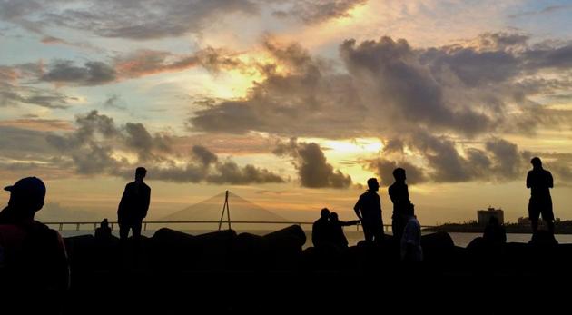 People at Dadar beach during sunset in Mumbai on June 11, with the Bandra Worli Sea Link in the back. India is currently the fourth worst hit country globally due to the coronavirus pandemic. (Satish Bate / HT Photo) People at Dadar beach during sunset in Mumbai on June 11, with the Bandra Worli Sea Link in the back. India is currently the fourth worst hit country globally due to the coronavirus pandemic. (Satish Bate / HT Photo)