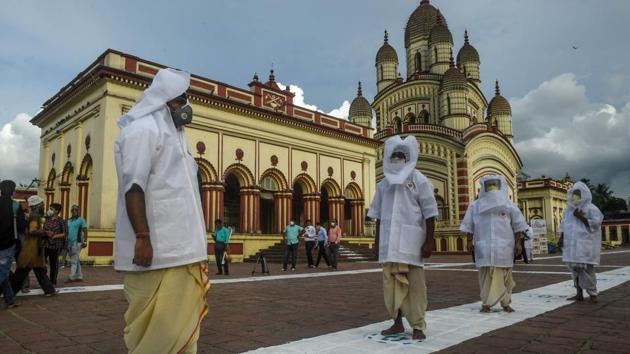 Priests wearing face masks and head covers maintain social distancing at the Dakshineswar Kali Temple, following the reopening of places of worship, in Kolkata. At an average, 329 deaths have been reported every day in the past week. This number was 238 in the seven days before that. The case fatality rate (CFR) in the country stood at 2.9%, significantly lower than the worldwide figure of 5.6%. (Dibyangshu SARKAR / AFP) Priests wearing face masks and head covers maintain social distancing at the Dakshineswar Kali Temple, following the reopening of places of worship, in Kolkata. At an average, 329 deaths have been reported every day in the past week. This number was 238 in the seven days before that. The case fatality rate (CFR) in the country stood at 2.9%, significantly lower than the worldwide figure of 5.6%. (Dibyangshu SARKAR / AFP)