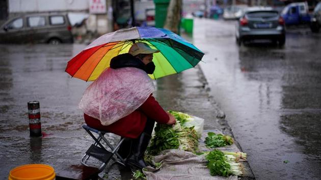 A vegetables vendor wearing a face mask waits for customers in the rain in Jingzhou, after the lockdown was eased in Hubei province, the epicentre of China's coronavirus disease outbreak.(REUTERS/For Representative Purposes Only) A vegetables vendor wearing a face mask waits for customers in the rain in Jingzhou, after the lockdown was eased in Hubei province, the epicentre of China's coronavirus disease outbreak.(REUTERS/For Representative Purposes Only)