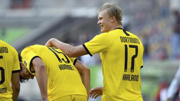 Dortmund's Erling Haaland, right, celebrates after scoring the opening goal during the German Bundesliga soccer match between Fortuna Duesseldorf and Borussia Dortmund in Duesseldorf.(AP)