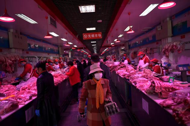 In this file photo, customers seen buying supplies at the Xinfadi wholesale market in Beijing.(REUTERS)