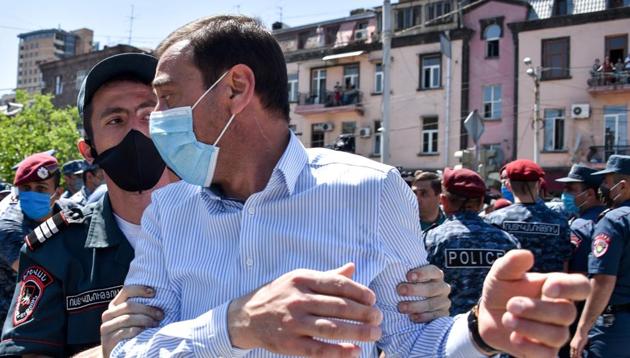 Police officer detains a supporter of opposition leader Gagik Tsarukian during a unauthorised rally close to National security service headquarter in Yerevan on June 14, 2020.(AFP photo)