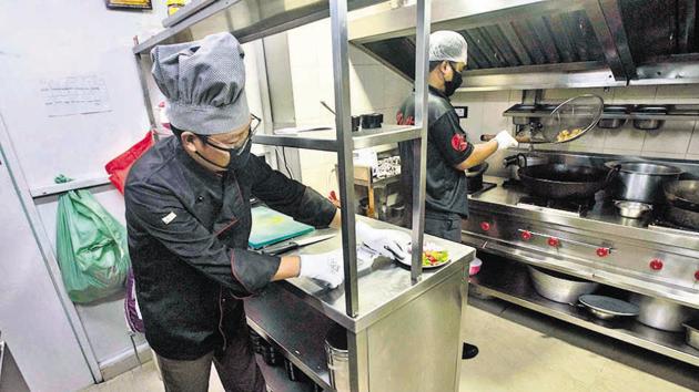 Chefs work at operation kitchen for take away at Zillionth Bistro in Kothrud. (Pratham Gokhale/HT Photo) Chefs work at operation kitchen for take away at Zillionth Bistro in Kothrud. (Pratham Gokhale/HT Photo)