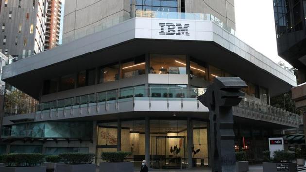 A man wearing a protective mask walks past an office building with IBM logo amidst the easing of the coronavirus disease restrictions in the Central Business District of Sydney, Australia.(REUTERS)