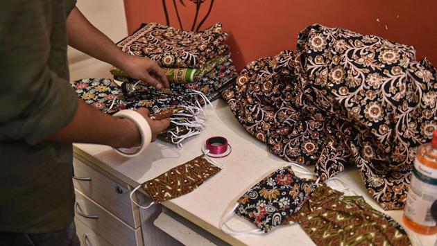 “These are reusable cotton masks. Every day, around 25-40 masks are made and put into boxes at five locations in Chittaranjan Park,” Das said. The boxes in which these masks are put have been designed by Sourav Das to ensure contactless access. Four of the five boxes have been placed in markets. (Arun Sharma / PTI) “These are reusable cotton masks. Every day, around 25-40 masks are made and put into boxes at five locations in Chittaranjan Park,” Das said. The boxes in which these masks are put have been designed by Sourav Das to ensure contactless access. Four of the five boxes have been placed in markets. (Arun Sharma / PTI)