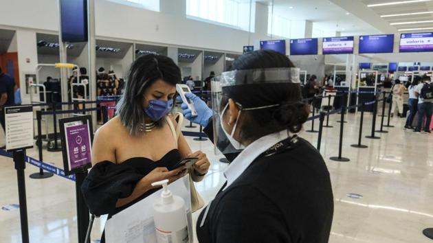 Staff checks a woman’s temperature amid the Covid-19 pandemic in Cancun, Mexico. (AP file photo) Staff checks a woman’s temperature amid the Covid-19 pandemic in Cancun, Mexico. (AP file photo)