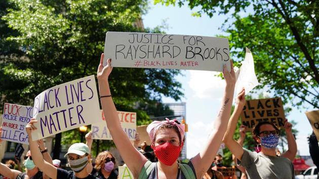 Protesters rally against racial inequality and the police shooting death of Rayshard Brooks, in Atlanta, Georgia, US. (REUTERS) Protesters rally against racial inequality and the police shooting death of Rayshard Brooks, in Atlanta, Georgia, US. (REUTERS)