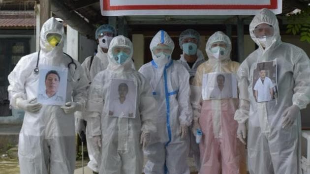 Doctors, nurses and attendants at Miao Covid-19 care centre in Changlang district of Arunachal Pradesh are seen with their photos pasted over PPE kits. (HT photo) Doctors, nurses and attendants at Miao Covid-19 care centre in Changlang district of Arunachal Pradesh are seen with their photos pasted over PPE kits. (HT photo)