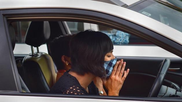 A member of a Church prays while sitting in her car after parking it on ground during drive-in worship, amid the ongoing Covid-19 lockdown, in Bengaluru. (PTI) A member of a Church prays while sitting in her car after parking it on ground during drive-in worship, amid the ongoing Covid-19 lockdown, in Bengaluru. (PTI)