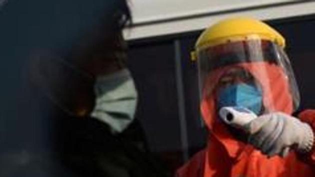 File photo: A worker in protective suit checks the temperature of a truck driver entering the Xinfadi wholesale market, China. (Reuters) File photo: A worker in protective suit checks the temperature of a truck driver entering the Xinfadi wholesale market, China. (Reuters)