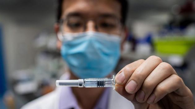 An engineer displaying an experimental vaccine for the Covid-19 coronavirus that was tested at the Quality Control Laboratory at the Sinovac Biotech facilities in Beijing. (AFP) An engineer displaying an experimental vaccine for the Covid-19 coronavirus that was tested at the Quality Control Laboratory at the Sinovac Biotech facilities in Beijing. (AFP)