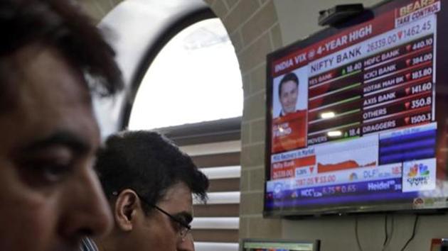 Indian stockbrokers watch the Bombay Stock Exchange (BSE) index on a trading terminal in Mumbai, India (AP)