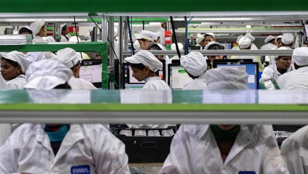 Employees test mobile phones on an assembly line in the mobile phone plant. (Bloomberg File Photo/Representative Image) Employees test mobile phones on an assembly line in the mobile phone plant. (Bloomberg File Photo/Representative Image)
