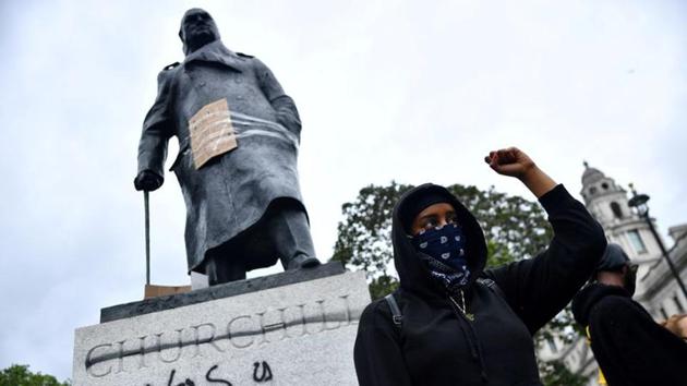 A demonstrator reacts infront of graffiti on a statue of Winston Churchill in Parliament Square during a Black Lives Matter protest in London following the death of George Floyd who died in police custody in Minneapolis, London on June 7, 2020.(Reuters File Photo)