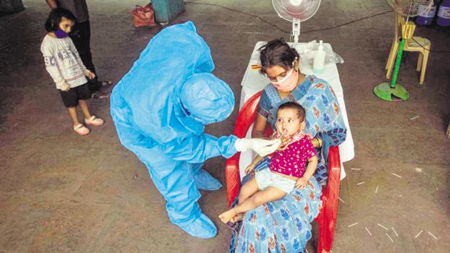 A healthcare worker collects oral swab sample of a child for Covid-19 test, at Sane Guruji Smarak, Sinhagad road, during lockdown, in Pune. (FOR REPRESENTATIONAL PURPOSE ONLY) A healthcare worker collects oral swab sample of a child for Covid-19 test, at Sane Guruji Smarak, Sinhagad road, during lockdown, in Pune. (FOR REPRESENTATIONAL PURPOSE ONLY)