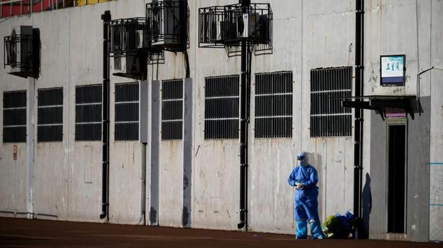 A medical professional wearing a protective suit is seen at the Guang’an Sport Centre before the mass swab testing began on June 14. The return of the coronavirus has shrouded Beijing. Home to the headquarters of several big corporations, China is trying to shake off the economic lull caused by the disease. (Noel Celis / AFP)