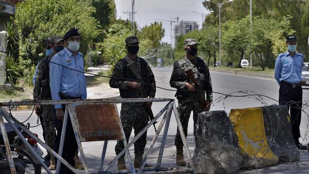 Pakistan paramilitary soldiers and a police officers stand guard at a checkpoint of a restricted area in Islamabad, Pakistan(AP)