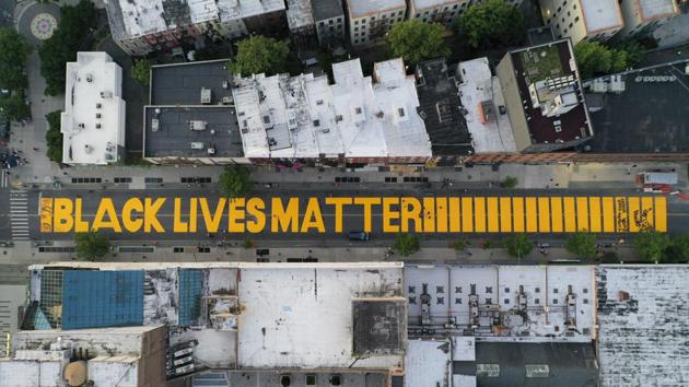 A giant "BLACK LIVES MATTER" sign is painted in orange on Fulton Street, Brooklyn borough of New York. (AP) A giant "BLACK LIVES MATTER" sign is painted in orange on Fulton Street, Brooklyn borough of New York. (AP)