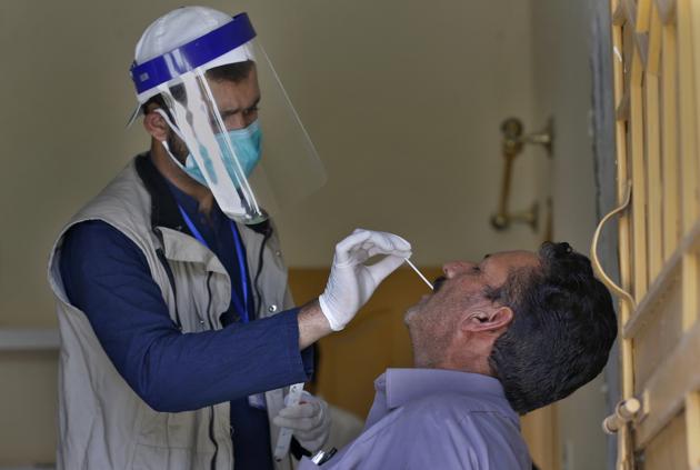 Islamabad: A health worker takes a nasal swab sample of a person during door-to-door testing and screening facility for the new coronavirus, in Islamabad, Pakistan, Monday, June 15, 2020. AP/PTI(AP15-06-2020_000167B) (AP)