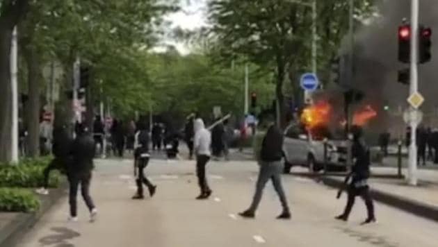 This frame grab provided by BFM TV shows youths, some holding sticks, walking by a burning car in Dijon, central France, Monday June 15, 2020. (AP photo) This frame grab provided by BFM TV shows youths, some holding sticks, walking by a burning car in Dijon, central France, Monday June 15, 2020. (AP photo)