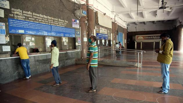People queue while keeping distance at a ticketing booth in Vashi Railway Station on June 15. Nearly 40,000 railway tickets were sold on the first day that trains resumed. The expected estimate of essential service employees who would commute by local train is approximately 1.25 lakh, the figure rising as awareness spreads about services. (Bachchan Kumar / HT Photo) People queue while keeping distance at a ticketing booth in Vashi Railway Station on June 15. Nearly 40,000 railway tickets were sold on the first day that trains resumed. The expected estimate of essential service employees who would commute by local train is approximately 1.25 lakh, the figure rising as awareness spreads about services. (Bachchan Kumar / HT Photo)