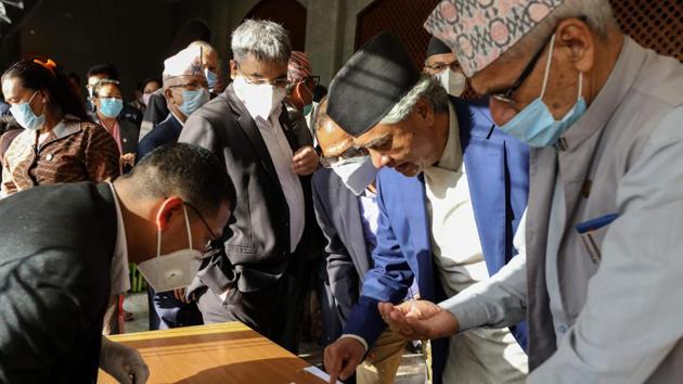 Nepal's House of Representatives members sign as they vote on an amendment to update the national emblem with a new controversial political map in Kathmandu on June 13, 2020.(AFP)