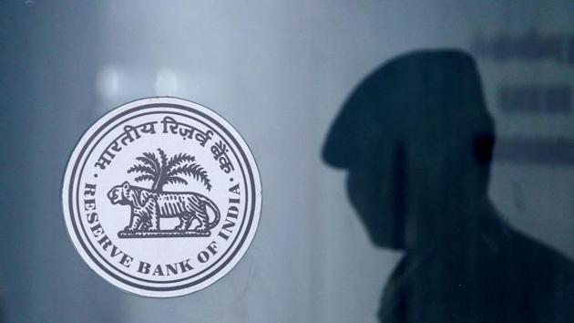 A security guard's reflection is seen next to the logo of the Reserve Bank Of India (RBI) at the RBI headquarters in Mumbai. (REUTERS) A security guard's reflection is seen next to the logo of the Reserve Bank Of India (RBI) at the RBI headquarters in Mumbai. (REUTERS)