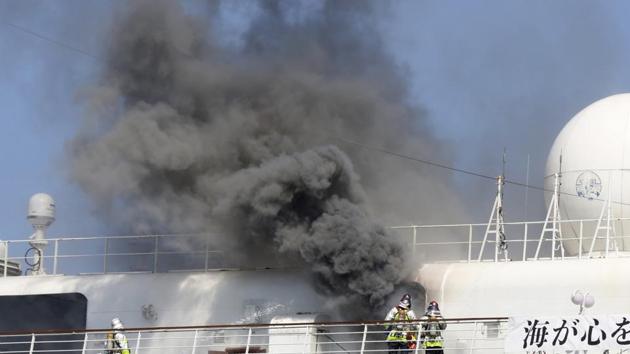 Smoke rises from Japanese cruise ship Asuka II docked in Yokohama Port, in Yokohama near Tokyo.(AP)