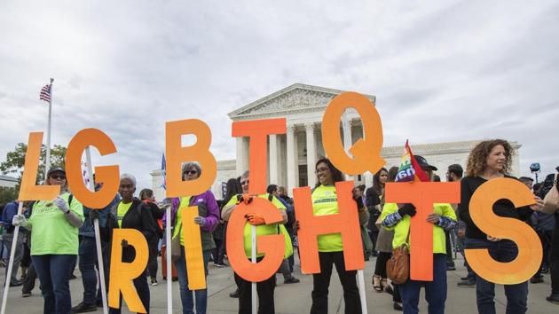 File photo of supporters of LGBTQ rights holding placards in front of the U.S. Supreme Court in Washington. (AP File) File photo of supporters of LGBTQ rights holding placards in front of the U.S. Supreme Court in Washington. (AP File)