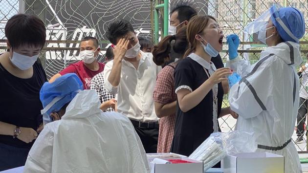 Residents line up to get tested at a coronavirus testing center set up outside a sports facility in Beijing, Tuesday, June 16, 2020. China reported several dozen more coronavirus infections Tuesday as it increased testing and lockdown measures in parts of the capital to control what appeared to be its largest outbreak in more than two months. (AP Photo/Ng Han Guan) (AP) Residents line up to get tested at a coronavirus testing center set up outside a sports facility in Beijing, Tuesday, June 16, 2020. China reported several dozen more coronavirus infections Tuesday as it increased testing and lockdown measures in parts of the capital to control what appeared to be its largest outbreak in more than two months. (AP Photo/Ng Han Guan) (AP)