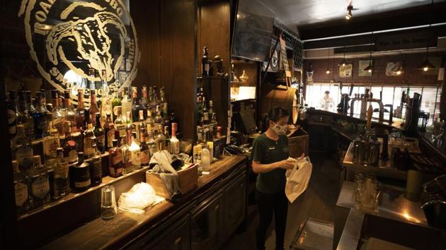 A worker wearing a face mask to help curb the spread of the coronavirus as she cleans a glass in front of the bar area at Roadhouse Barbecue restaurant in Bangkok, Thailand, Monday, June 15, 2020. Restaurants will no longer be banned from serving alcohol. Thai government continues to ease restrictions related to running business in capital Bangkok that were imposed weeks ago to combat the spread of COVID-19. (AP Photo/Sakchai Lalit) (AP) A worker wearing a face mask to help curb the spread of the coronavirus as she cleans a glass in front of the bar area at Roadhouse Barbecue restaurant in Bangkok, Thailand, Monday, June 15, 2020. Restaurants will no longer be banned from serving alcohol. Thai government continues to ease restrictions related to running business in capital Bangkok that were imposed weeks ago to combat the spread of COVID-19. (AP Photo/Sakchai Lalit) (AP)