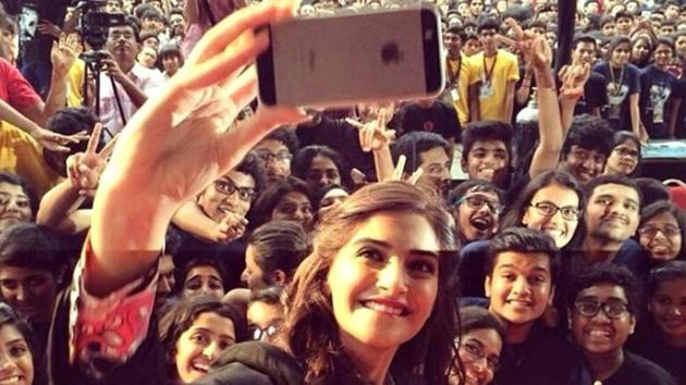 Actor Sonam Kapoor is seen clicking a selfie with fan at an event. Actor Sonam Kapoor is seen clicking a selfie with fan at an event.