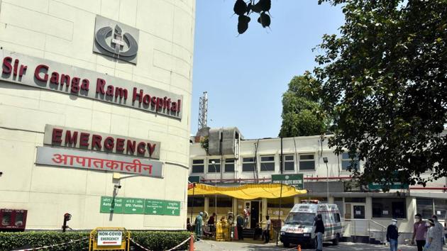 Medical professionals wearing PPE coveralls and visitors seen outside the Covid-19 ward at Sir Ganga Ram Hospital, in New Delhi. (Sonu Mehta/HT PHOTO)