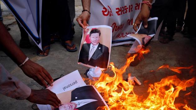 Demonstrators burn posters of Chinese President Xi Jinping during a protest against China, in Ahmedabad.(REUTERS)