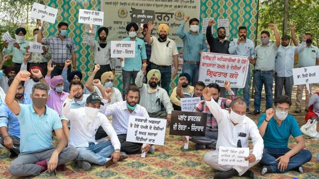 Agriculture department employees holding a protest against the attack on their two colleagues in Ludhiana on Tuesday. (Harsimar Pal Singh/HT) Agriculture department employees holding a protest against the attack on their two colleagues in Ludhiana on Tuesday. (Harsimar Pal Singh/HT)