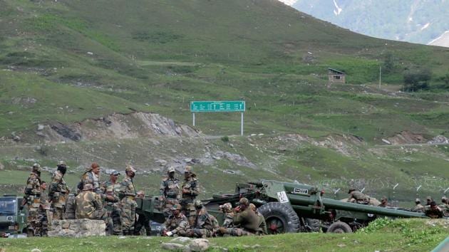 Indian army soldiers rest next to artillery guns at a makeshift transit camp before heading to Ladakh, near Baltal, southeast of Srinagar.(REUTERS) Indian army soldiers rest next to artillery guns at a makeshift transit camp before heading to Ladakh, near Baltal, southeast of Srinagar.(REUTERS)