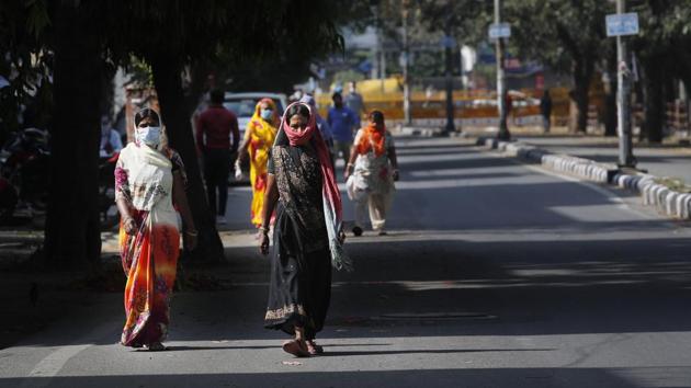 Household maids wearing face masks as precaution against coronavirus arrive for work in the morning in New Delhi. (AP) Household maids wearing face masks as precaution against coronavirus arrive for work in the morning in New Delhi. (AP)