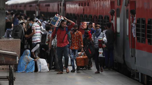 Migrant laborers walk with their belongings after arriving from Maharashtra state, in Prayagraj.(AP) Migrant laborers walk with their belongings after arriving from Maharashtra state, in Prayagraj.(AP)