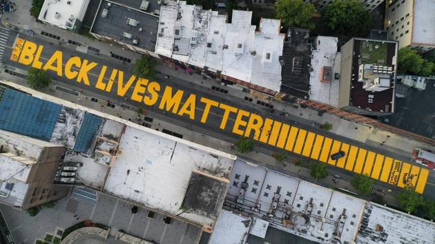 FILE - A giant BLACK LIVES MATTER sign is painted in orange on Fulton Street, New York. (AP/John Minchillo) FILE - A giant BLACK LIVES MATTER sign is painted in orange on Fulton Street, New York. (AP/John Minchillo)
