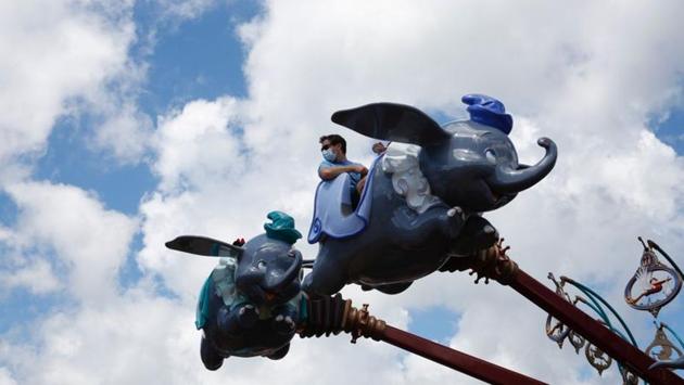 A visitor wearing a face mask seen on a ride at Disneyland Resort in Hong Kong. Without tourists, business for Disneyland in Hong Kong is likely to remain subdued. It will have to rely on a domestic market that was struggling with recession after months of often violent pro-democracy protests even before the coronavirus blow. (Tyrone Siu / REUTERS) A visitor wearing a face mask seen on a ride at Disneyland Resort in Hong Kong. Without tourists, business for Disneyland in Hong Kong is likely to remain subdued. It will have to rely on a domestic market that was struggling with recession after months of often violent pro-democracy protests even before the coronavirus blow. (Tyrone Siu / REUTERS)