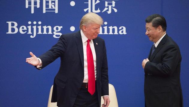 US President Donald Trump gestures next to China's President Xi Jinping during a business leaders event at the Great Hall of the People in Beijing in November 2017. (AFP File Photo) US President Donald Trump gestures next to China's President Xi Jinping during a business leaders event at the Great Hall of the People in Beijing in November 2017. (AFP File Photo)