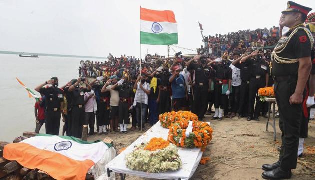 An army officer pays tribute to Havildar Sunil Kumar during his last rites, in Maner. (PTI) An army officer pays tribute to Havildar Sunil Kumar during his last rites, in Maner. (PTI)