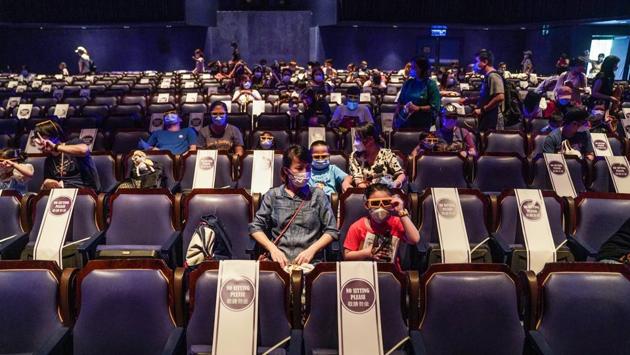 Stickers are seen on seats for proper adherence of social distancing as visitors wait to watch the ‘Mickey’s PhilharMagic’ show at Disneyland Resort. The park on its day of reopening also carried out frequent disinfection drives and made hand sanitisers available for the visitors. (Lam Yik / Bloomberg) Stickers are seen on seats for proper adherence of social distancing as visitors wait to watch the ‘Mickey’s PhilharMagic’ show at Disneyland Resort. The park on its day of reopening also carried out frequent disinfection drives and made hand sanitisers available for the visitors. (Lam Yik / Bloomberg)