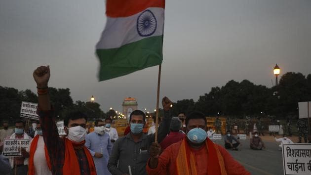 Members of ruling Bharatiya Janata Party march in front of India Gate monument in New Delhi, India, holding candles as tributes to Indian soldiers killed during confrontation with Chinese soldiers in the Ladakh region.(AP)