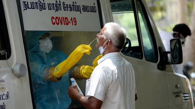 A health official collects a swab sample from a man to test for the Covid-19 test, Chennai, June 16, 2020(AFP)