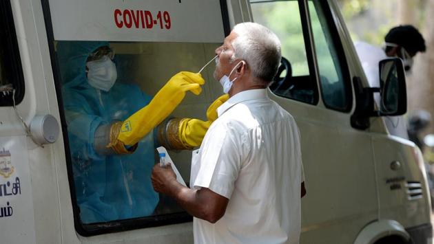A health worker collects a swab sample from a man to test for the COVID-19 coronavirus at a mobile testing centre in Chennai on June 16. The state breached the 50,000 cases benchmark on June 17. Tamil Nadu now has 50, 193 cases as of last count according to data compiled by covid19india.org and cross-checked by HT. (Arun Sankar / AFP) 