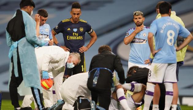 Manchester City's Eric Garcia receives medical attention after sustaining an injury as play resumes behind closed doors following the outbreak of the coronavirus disease (COVID-19).(REUTERS)